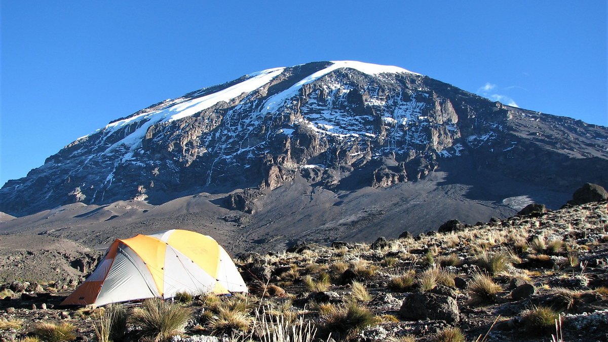 Trekking tent pitched below the Kibo peak of Kilimanjaro